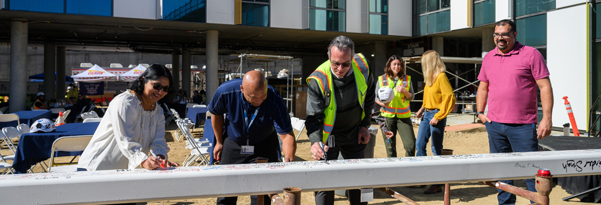 3 of 5, HDH members signing a beam at the pepper canyon west topping off event